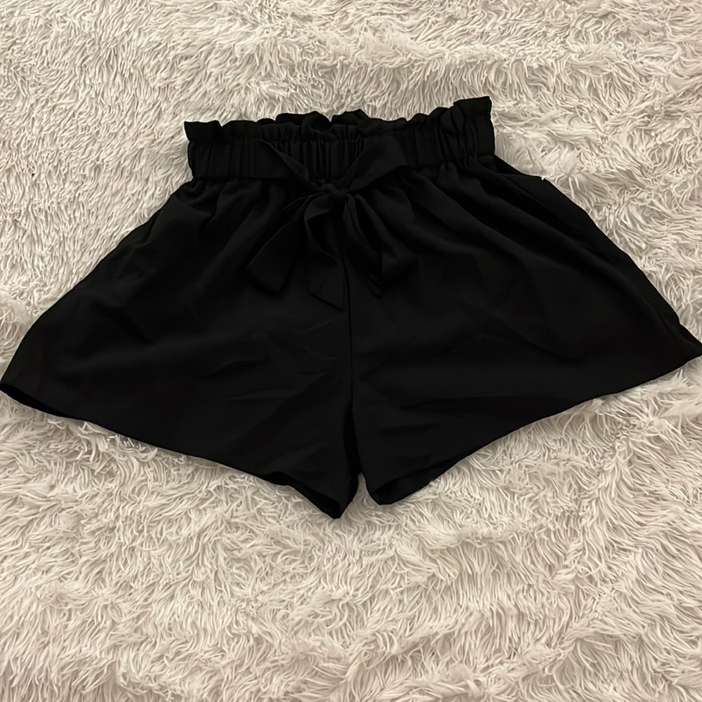 Black shorts, elastic waist and bow tie front. Loose fit!